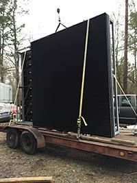 Large outdoor LED display cabinets being transported for installation
